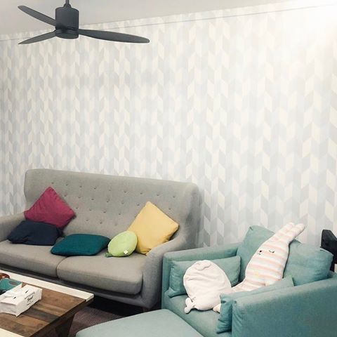 #FeatureFridays One of our latest living room projects! The client requested for the colours of the original print (swipe ➡ for the original print) to be more mellow to fit the mood of the room. We love how this pastel herringbone wallpaper complements the muted tones in the room with the vibrant pillows bringing a nice pop of colour.