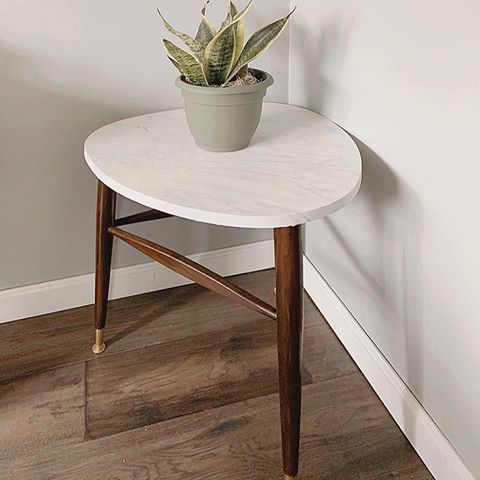 My favorite DIY projects are ones that cheap and inexpensive! Swipe left to see how I transformed this outdated side table into a modern faux marble top piece!  My mother in law picked this table up off the curb so I got it for free!! First, I sanded the legs a bit and used a gel stain I already had to darken them slightly. Next, I used gold spray paint I already had for the feet of the legs. Then, I bought marble contact paper and applied it over the top. And there you have it! I was originally going to sell it but I love how it turned out so I haven’t been able to part with it! 
Tell me about your easiest or most inexpensive DIY and tag me so I can see it!
.
.
.
.
.
#mymodernlook #mybhg #myhousebeautiful #homesweethome #diyprojects #doingneutralright #myinteriorvibe #eclectichome #sodomino
#myspaceanddecor #howwedwell #hunkerhome #simplehomestyle #apartmenttherapy
#neutraldecor #dailydecordose #showmeyourstyled #modernfarmhouse #inmydomaine #fixerupper #acaseoftheneutrals  #insta_neighborly #decor_bffs #thediyhomedecortribe #checkoutmydiy #ffinstagirls #interiordecor #westelminspired