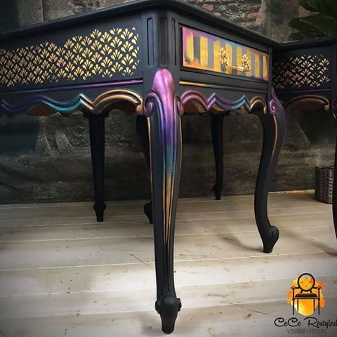These end tables are packed with personality! @cece_restyled used a 3Dstencil on the tops and Stick and Style Stencil Roll on the sides then added her signature stripes. Finishing with a gorgeous multi colored finish using the Art Alchemy Waxes!! So cool ❤️
#Repost @cece_restyled
・・・
Friday Greetings Fine Folks!
I finished up this fancy lil' set of nightstands last night...I VERY rarely paint black so it was nice to do so!  And, rainbow colors make everything better, of course :-) Stick and Style adhesive roll stencils (best thing since sliced bread) from @redesignwithprima on the sides, and the beautiful rich accent colors are @finnabair_studio Art Alchemy Metallique waxes.. both products from @primamarketinginc 🙌 -XOXO
#furnitureartist #furnituretransfers #keepindyindie #furnituremakeover #furniturerefinishing #furniture #refinishedfurniture #furniturerefinishing #chalkpaintedfurniture #chalkpaint #primatransfers #art #artist #artisan #indianapolis #indiana #paintedfurniture #cecerestyled