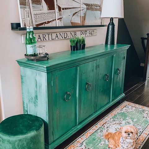You guys have the best memories!  I have had at least a half a dozen of you ask if we ended up purchasing the green side bar I shared in stories a few weeks ago and the answer is YES!
Here she is in all her glory...still not styled perfectly, I’m on the lookout for a long rectangular tray so if anyone sees one on their journey let me know, thrifted would be great!! And that’s my kitchen runner from @wayfaircanada,  a perfect match or what?
Hubby hung two more @ikeacanada picture ledges for me, one large one small, butted together (like we did in the living room) so I could display one of my most prized possessions, the 3 piece canvas of the Longest Covered Bridge in the World!  This beautiful landmark is in my hometown, where I was born and raised, in Hartland, New Brunswick 🇨🇦. How many of you have seen her?  Or better yet drove or walked through her?  It’s one of the first things we always do when we go Home for a visit.
And to answer your other burning decor questions....we had planned to use three pieces of furniture we brought with us from our last home but they were not a good fit.  So in my usual thrifty fashion, I sold them so we could buy something different!  The side bar is from @bennettsfurniture, the cute stool was on clearance from @walmartcanada, the runner is from @wayfaircanada and the picture ledges are of course @ikeacanada.  We’ve continued the same paint colour “Off White” by @behrpaint out into this hallway.
I’m loving green so much and I totally see it as a neutral in #mymonochromehome 💚
#sidebar #greenaccents #greenisthenewblack #modernrustic #thriftyshopper #homedecor #mystoryfilledhome #decorcircle #mymodernlook #makingmyhaven #storymesocial #behrmarquee #bhghome #wayfaircanada #wayfairathome #interior123 #interiordesign #showoffyourdecorstyle #howwedwell #diyer #diyblogger #myhomevibe #homestyling #letmeinspireyou #saynotoemptywalls #theblushhomepresets #doingneutralright #dogsindecor